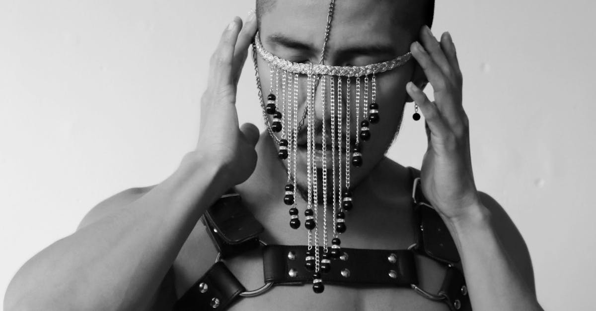 Black and White Studio Shoot of a Shirtless Man Wearing Accessories