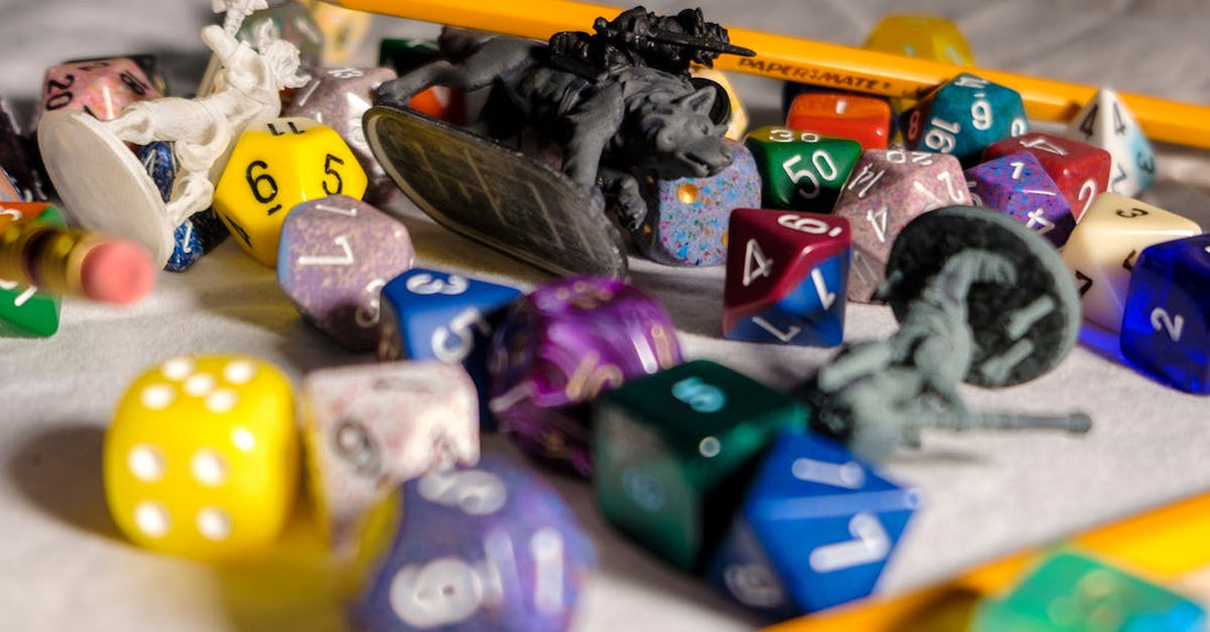 High angle of color dices in different shapes scattered on table with small toy animals and pencils during game