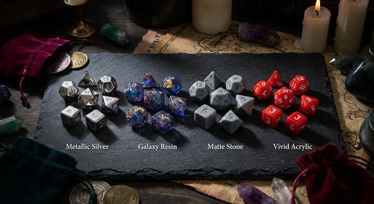 Four polyhedral dice sets made from different materials — metal, resin, stone, and acrylic — arranged dramatically on a dark slate surface under moody studio lighting.