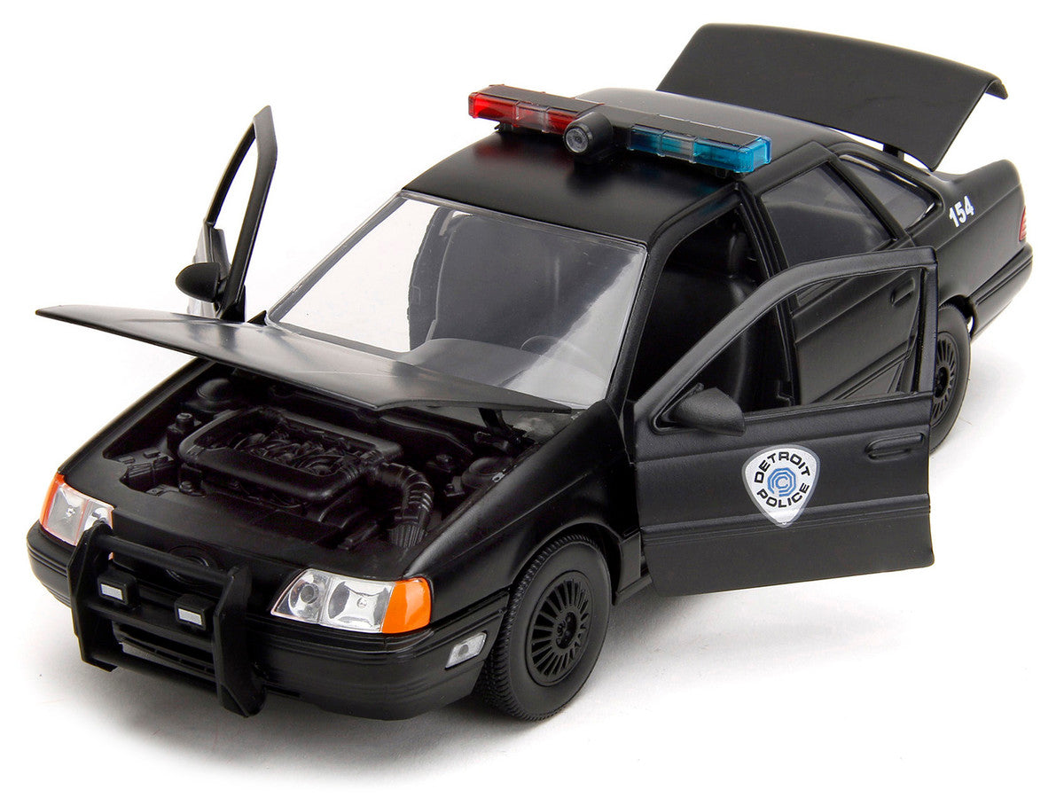 Ford Taurus OCP Matt Black "Detroit Police" and Robocop Diecast Figure 35th Anniversary "Robocop" (1987) Movie "Hollywood Rides" Series 1/24 Diecast Model Car by Jada-1