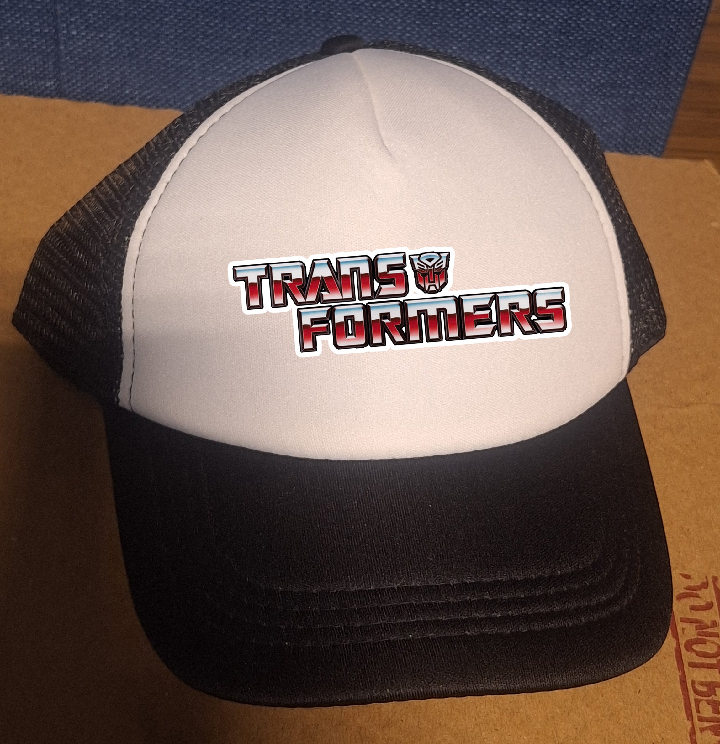 Adjustable Trucker Baseball Cap Featuring Retro 1980s Transformers Cartoon Logo